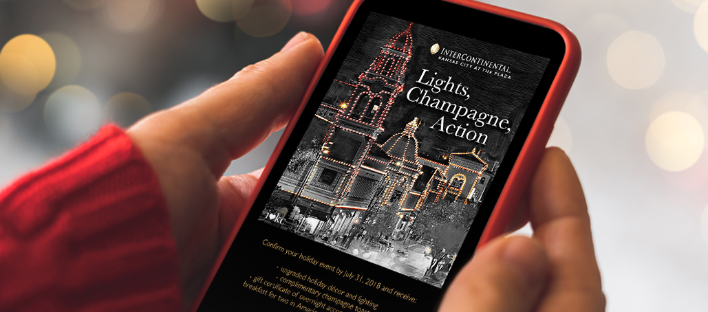 hands holding phone with holiday email on screen